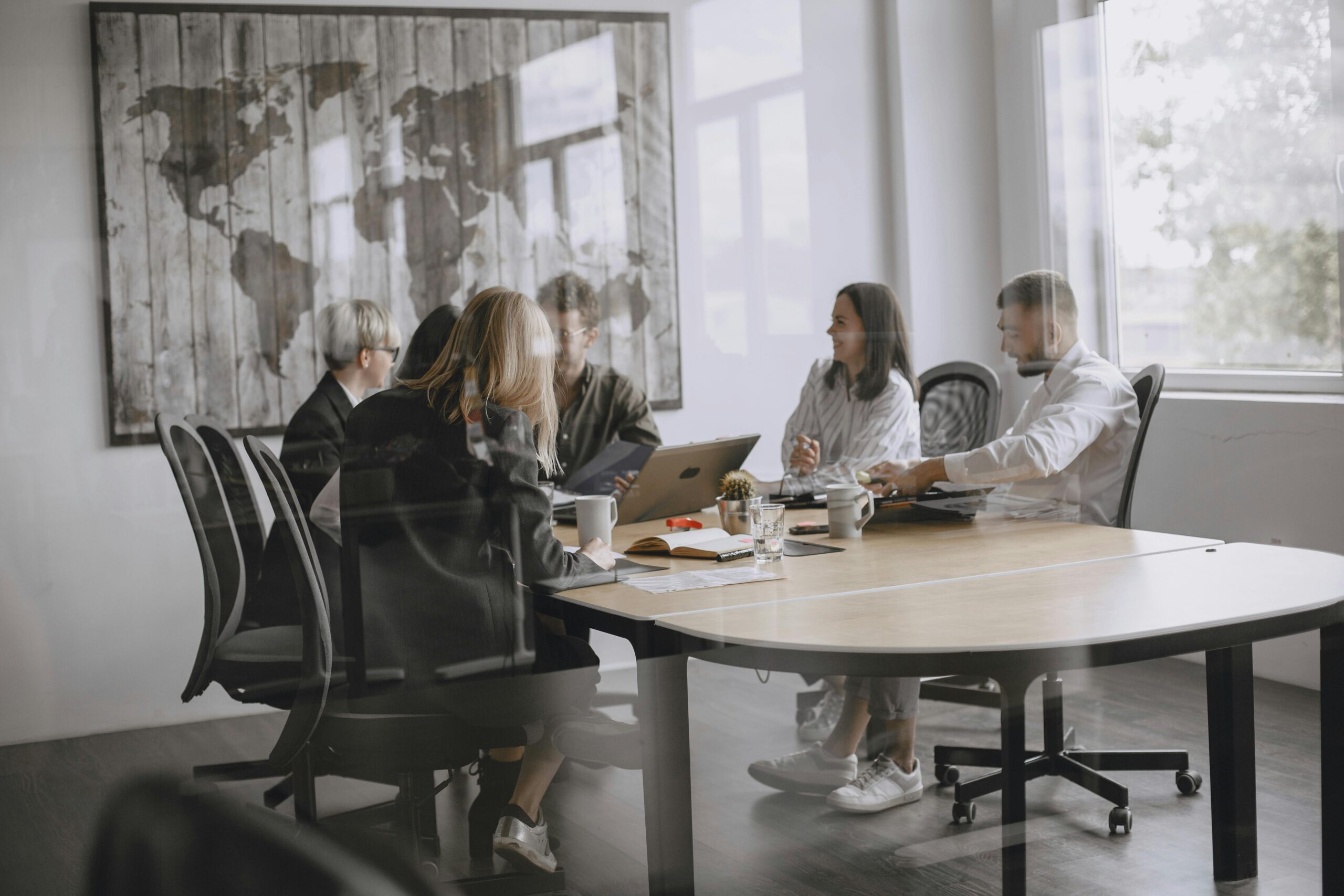 A diverse group of colleagues in a meeting in a modern office setting.