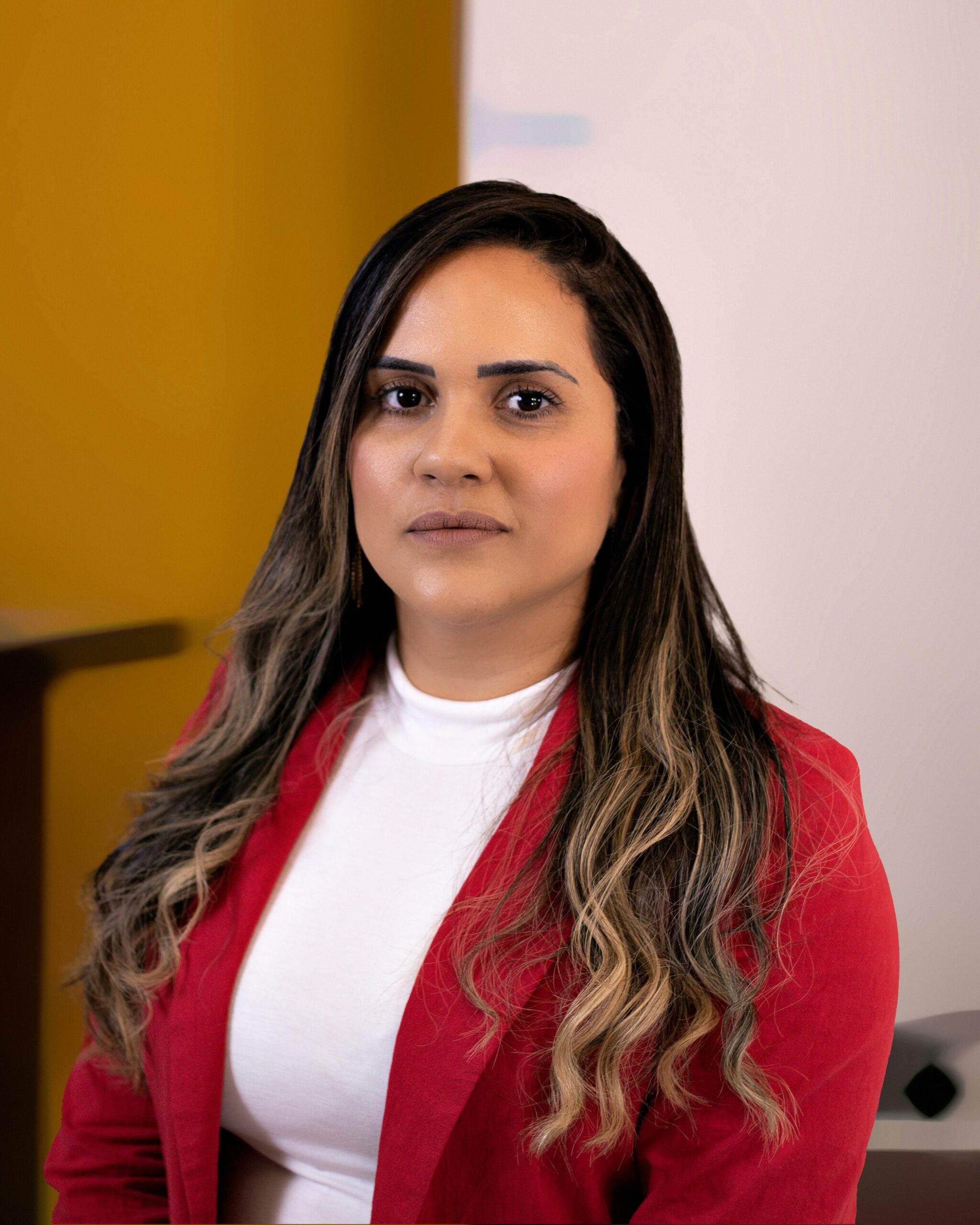 Portrait of a confident businesswoman in a red blazer, perfect for corporate profiles.